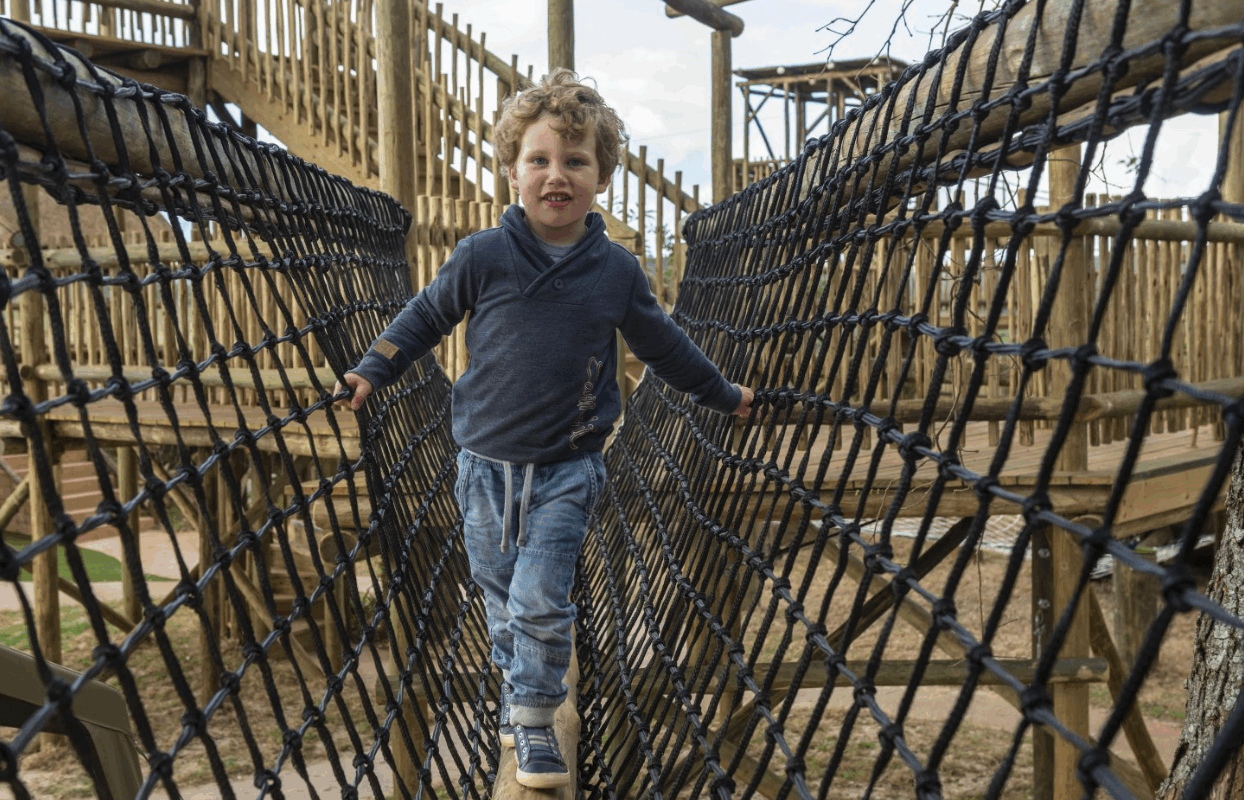 S009-IT2 - Smiling Toddler Playing on Jungle Gym Sustainable Safaris Africa - Journeys - Luxury Eastern Cape Family Safari - Smiling Toddler Playing on Jungle Gym